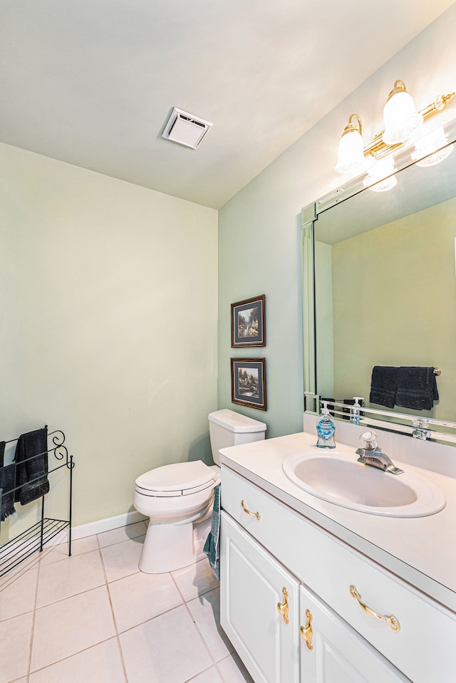 bathroom featuring tile patterned floors, vanity, and toilet