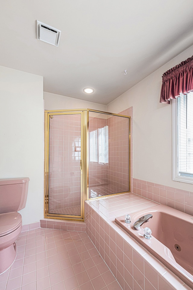 bathroom featuring tile patterned flooring, separate shower and tub, and toilet