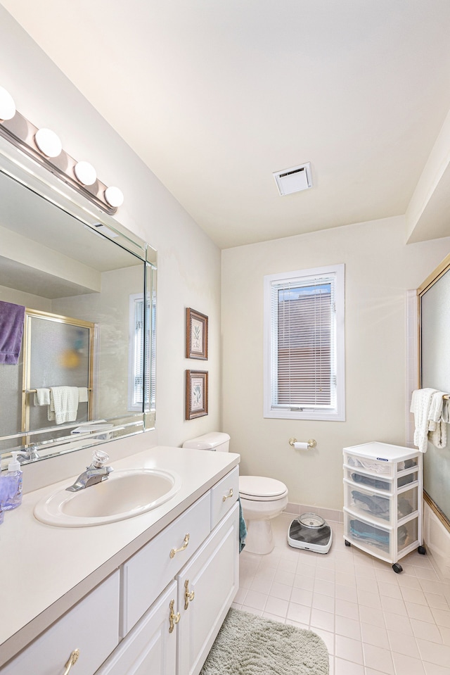 bathroom with tile patterned flooring, vanity, and toilet