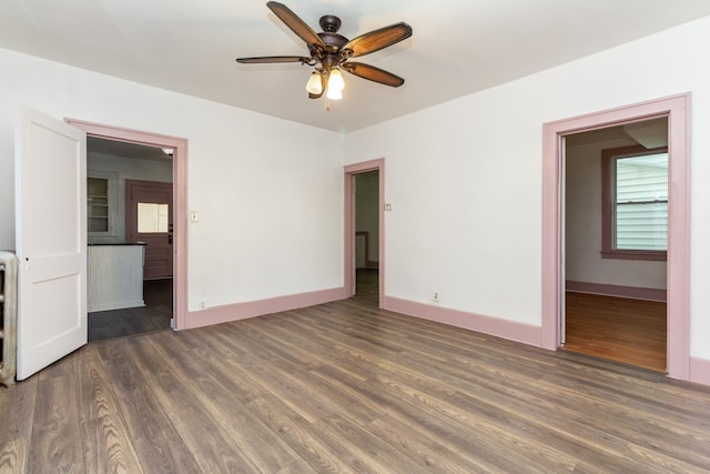 empty room featuring ceiling fan and dark wood-type flooring