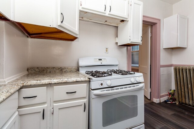 11434 Mcdougall St, Hamtramck, MI 48212 - kitchen featuring white gas stove, radiator, dark wood-style floors, white cabinets, and light stone counters