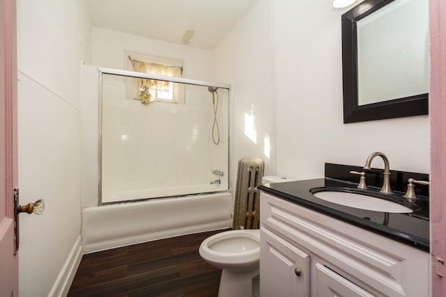 full bathroom with radiator, enclosed tub / shower combo, wood-type flooring, toilet, and vanity