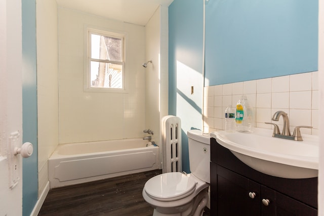 full bathroom with tasteful backsplash, vanity, bathing tub / shower combination, hardwood / wood-style flooring, and toilet