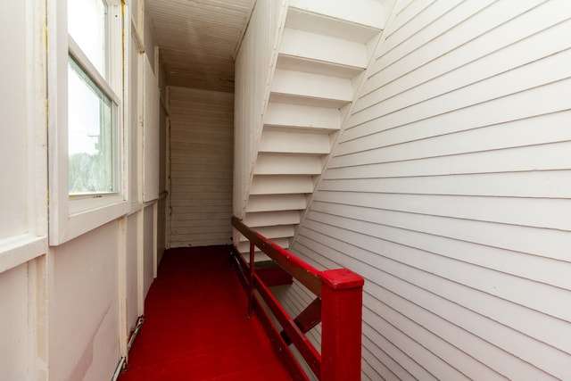 hallway featuring wood walls