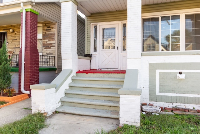 view of exterior entry with a porch