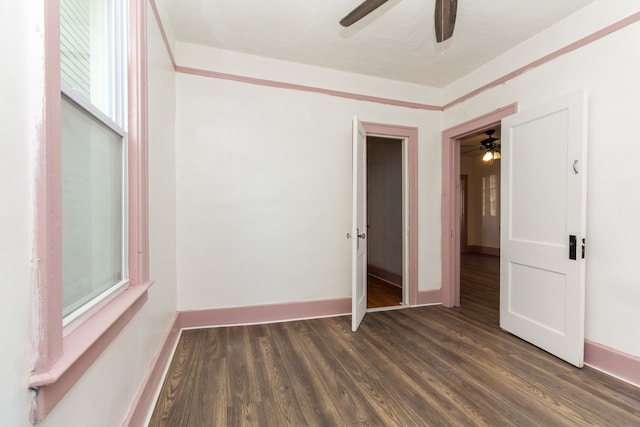 unfurnished bedroom with ceiling fan and dark hardwood / wood-style flooring