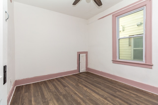 spare room featuring ceiling fan and dark wood-type flooring