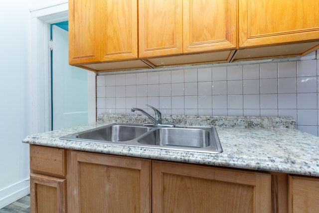 kitchen featuring decorative backsplash, sink, and hardwood / wood-style floors