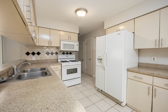 kitchen with sink, white appliances, cream cabinetry, decorative backsplash, and light tile patterned flooring