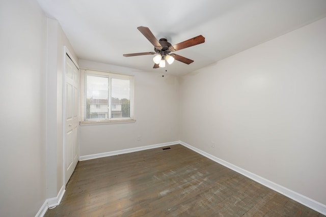 spare room with ceiling fan and dark hardwood / wood-style flooring