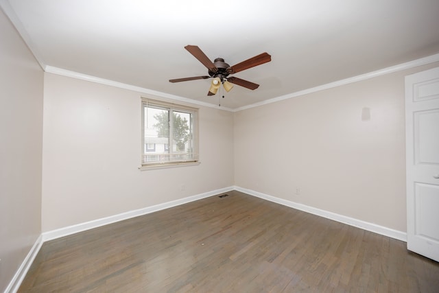 empty room featuring ceiling fan, dark wood-type flooring, and ornamental molding