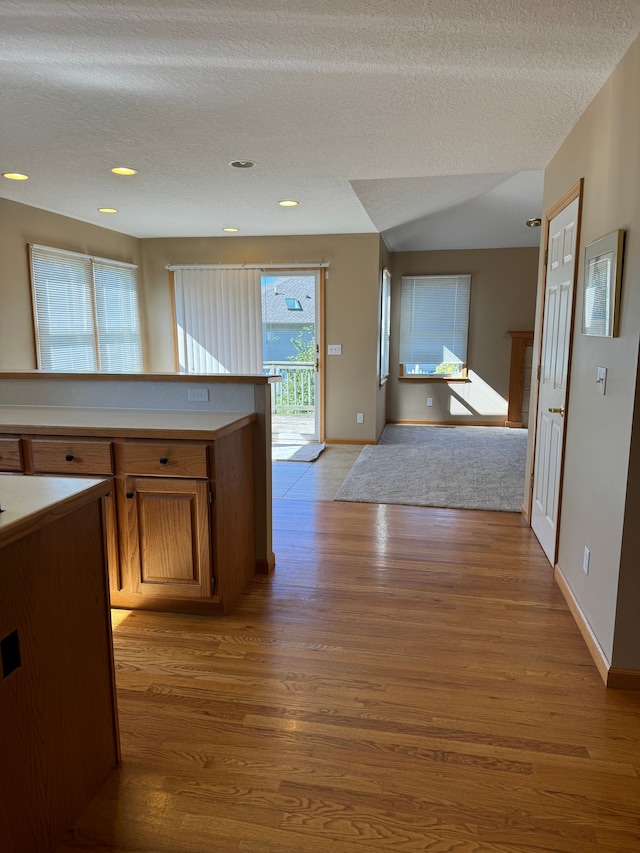 kitchen featuring light hardwood / wood-style floors and a textured ceiling