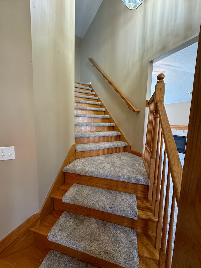 stairs with hardwood / wood-style floors