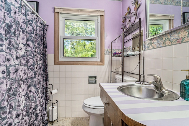 bathroom with a wealth of natural light and tile walls