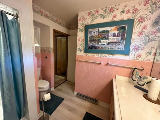 bathroom featuring hardwood / wood-style floors, vanity, tile walls, and toilet