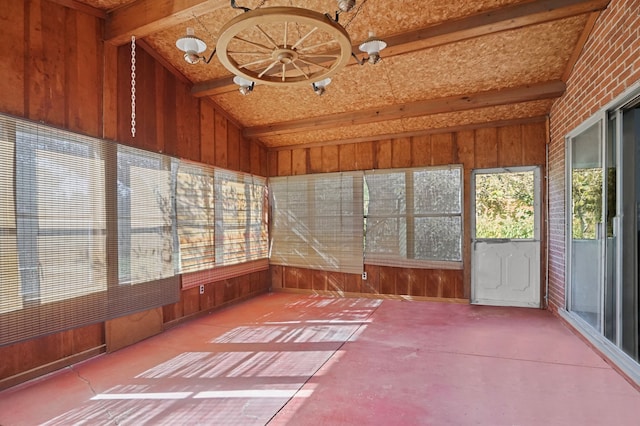 unfurnished sunroom with vaulted ceiling with beams