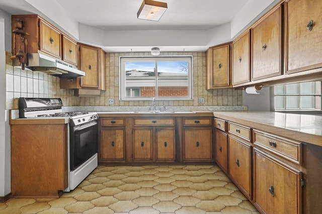 kitchen with sink, range with gas cooktop, and decorative backsplash