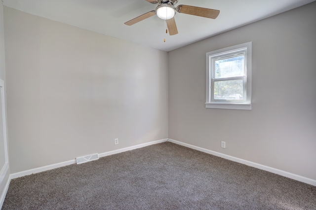 unfurnished room with visible vents, baseboards, and carpet