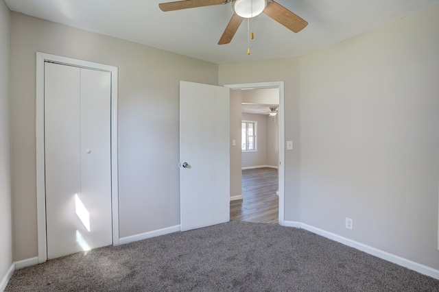 unfurnished bedroom featuring a closet, carpet flooring, ceiling fan, and baseboards