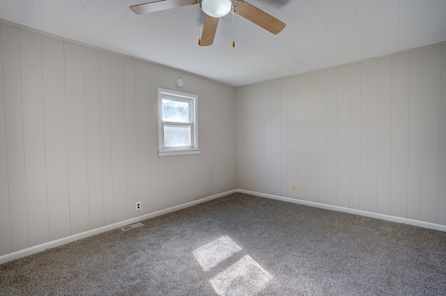 carpeted empty room featuring visible vents and baseboards