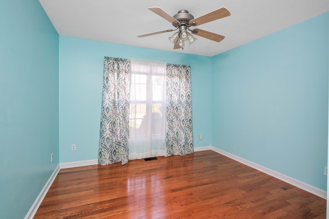 spare room featuring ceiling fan and dark hardwood / wood-style floors