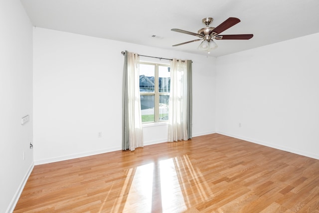 empty room with light wood-type flooring and ceiling fan