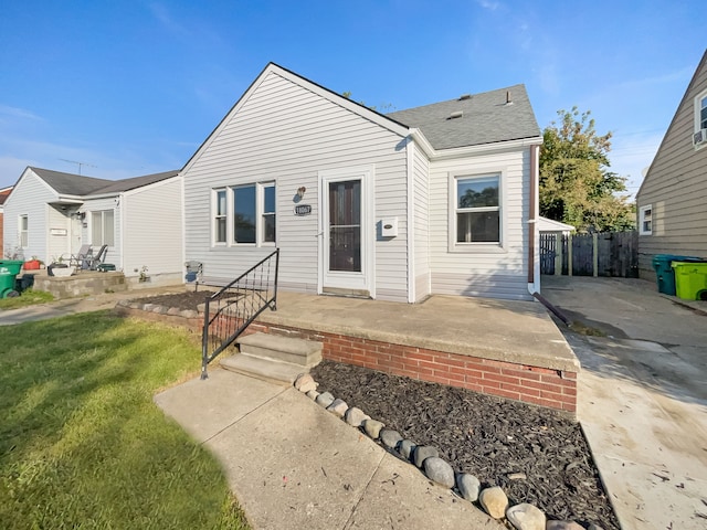 bungalow with a patio and a front lawn