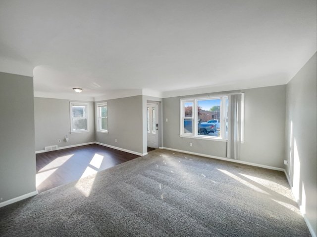 carpeted empty room with plenty of natural light