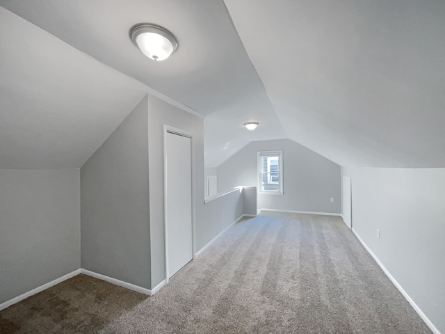 bonus room with carpet and vaulted ceiling