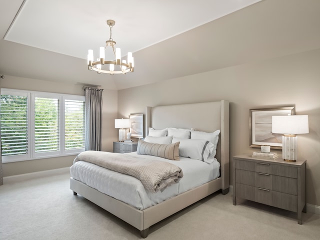 bedroom with light colored carpet and an inviting chandelier