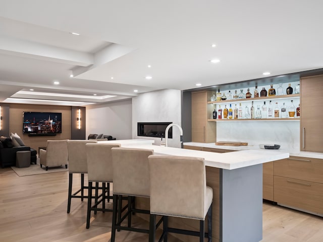 bar with light wood-type flooring