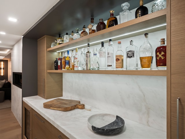 bar with wood-type flooring