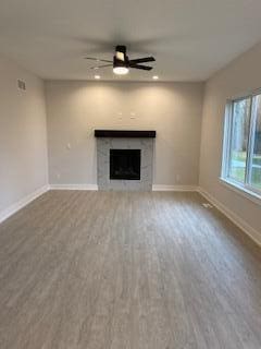 unfurnished living room with ceiling fan and hardwood / wood-style floors