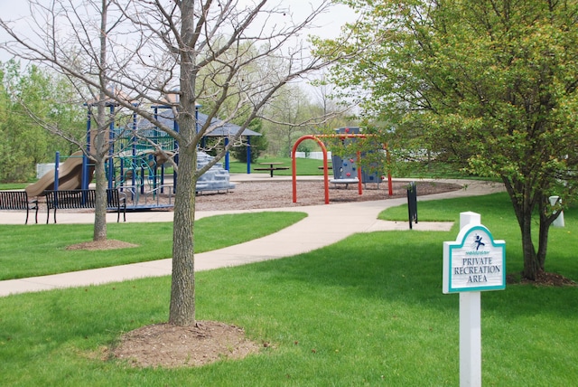 view of playground with a lawn