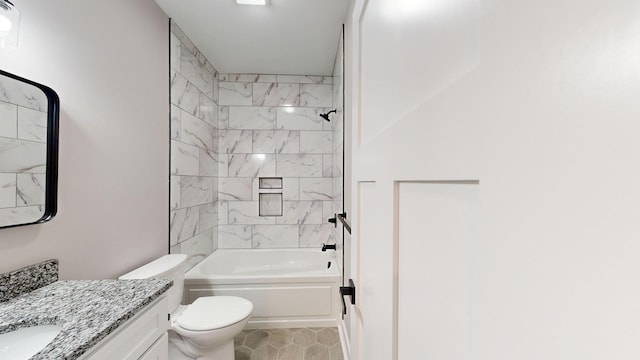 full bathroom featuring vanity, tiled shower / bath combo, and toilet