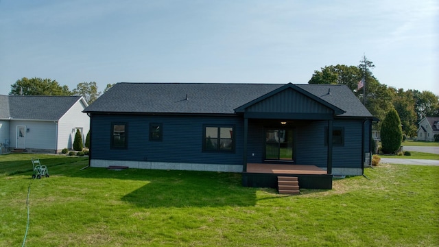 back of property featuring a lawn