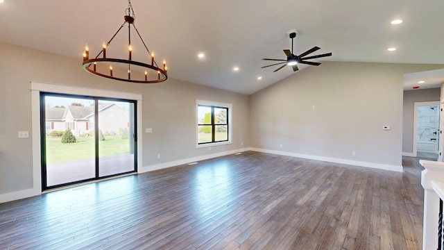 unfurnished living room featuring hardwood / wood-style floors, ceiling fan with notable chandelier, and vaulted ceiling