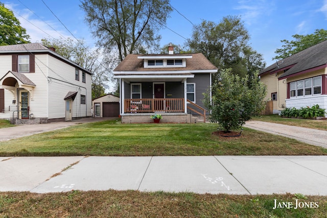 view of front facade featuring a front lawn, covered porch, an outdoor structure, and a garage