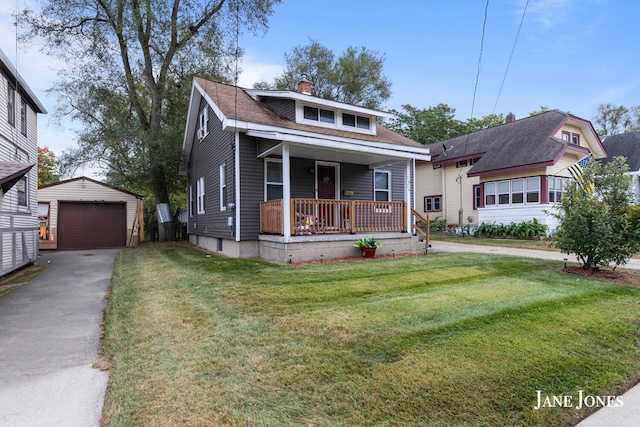 bungalow-style house featuring an outbuilding, a front lawn, covered porch, and a garage