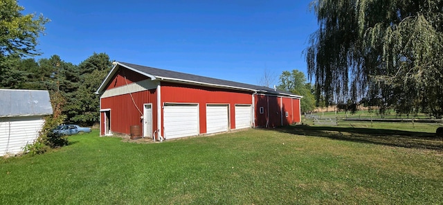 view of outdoor structure with a yard and a garage