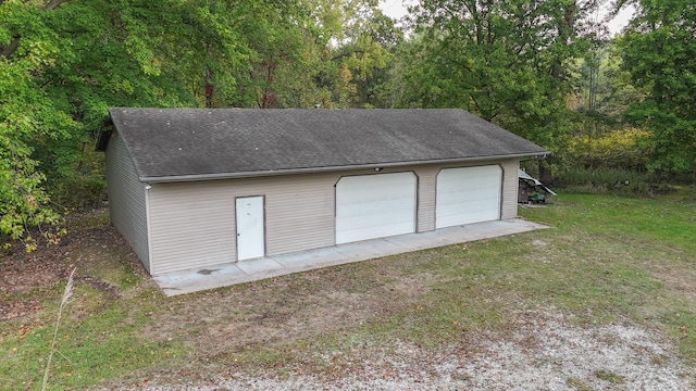 garage featuring a lawn