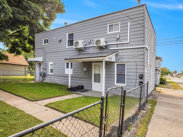 view of front property with ac unit and a front lawn