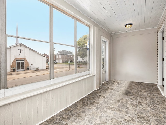 unfurnished sunroom with wood ceiling