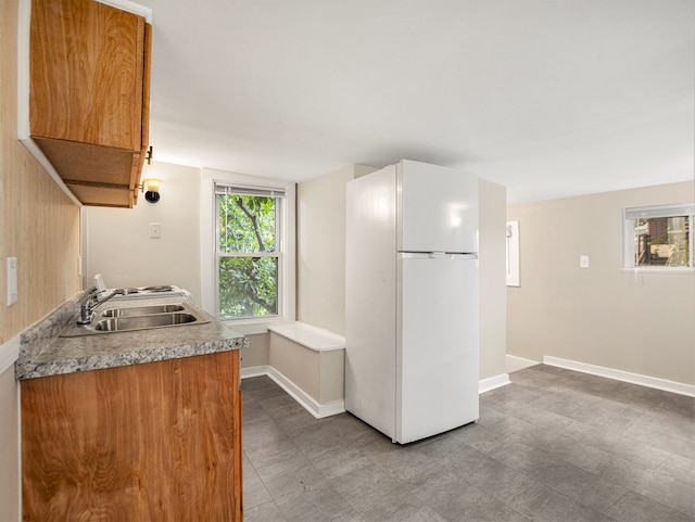 kitchen featuring white refrigerator and sink