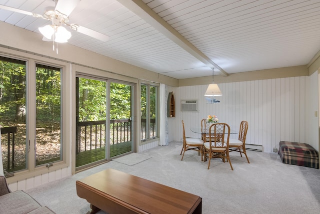 dining room with beamed ceiling, carpet floors, a wall unit AC, and a healthy amount of sunlight