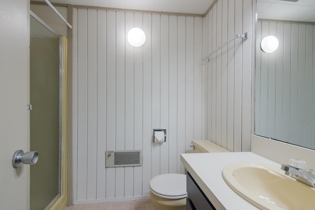 bathroom featuring walk in shower, tile patterned flooring, toilet, wooden walls, and vanity