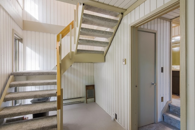 stairs with wood walls and concrete flooring