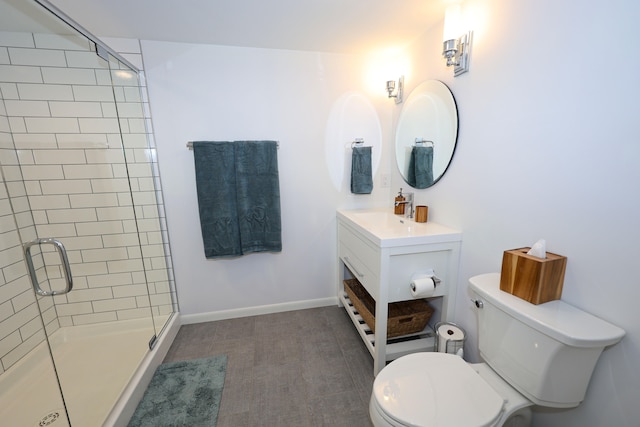 bathroom with vanity, toilet, and a shower with shower door