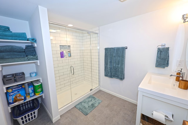 bathroom with vanity and a shower with door