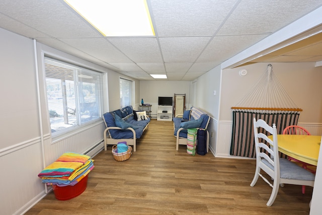 interior space featuring hardwood / wood-style flooring and a drop ceiling